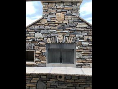 Cultured Stone Fireplace with Accent Lights built by Deck Works in Colorado Springs