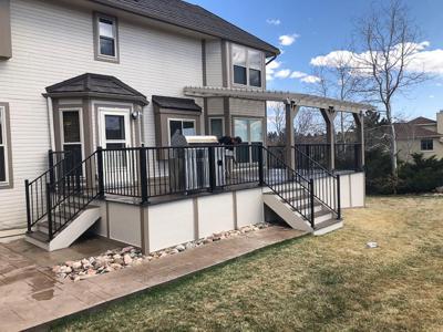 Composite Deck with Pergola, Iron Rail, Stairways and Deck Skirt built by Deck Works in Colorado Springs