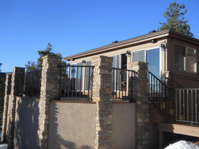 Stucco & Stone Deck with Jacuzzi House by Deck Works in Colorado Springs
