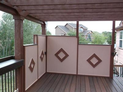 Painted Deck with Pergola, Stairway, Custom Rail, Accent Lighting and Storage Space by Deck Works in Colorado Springs