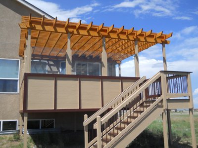 Painted Deck with Pergola, Accent Lighting and Stairway by Deck Works in Colorado Springs