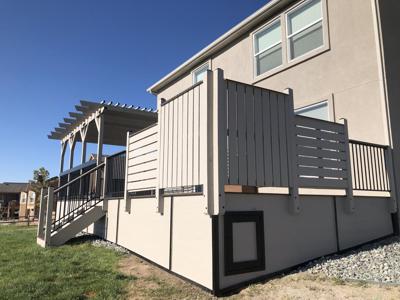 Composite Deck with Stairways, Pergola, Storage Box, Custom Rail & Wind Screen built by Deck Works in Colorado Springs