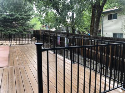 Composite Porch with Ramps and Iron Rail built by Deck Works in Colorado Springs
