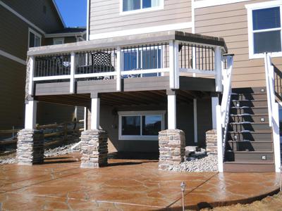 Stone Deck with Stairway, Decorative Concrete Patio, Custom Rail & Accent Lighting built by Deck Works in Colorado Springs
