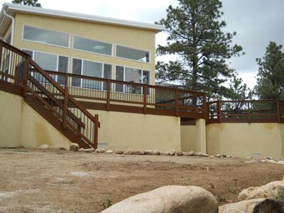 Stucco Deck with Jacuzzi Room, Storage Room, Custom Rail, Stairways, Benches & Accent Lighting bult by Deck Works in Colorado Springs