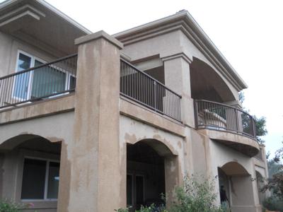 Stucco Deck with Cover, Iron Rails and Accent Lighting built by Deck Works in Colorado Springs
