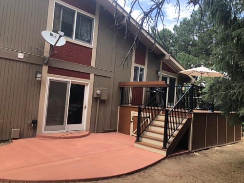 Composited Deck with Stairway, Deck Skirt, Iron Rail and Concrete Slab Built by Deck Works in Colorado Springs