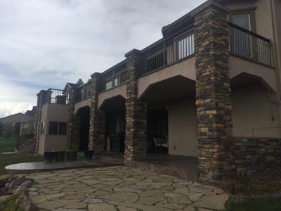 Stucco & Stone Deck with Storage Room by Deck Works in Colorado Springs