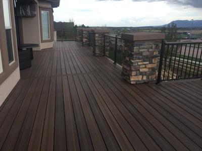 Stucco & Stone Deck with Storage Room by Deck Works in Colorado Springs