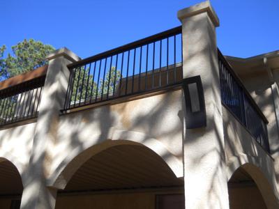 Stucco Deck with Iron Rails, Accent Lighting & Dry Below System built by Deck Works in Colorado Springs