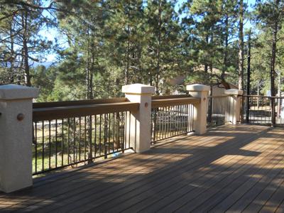 Stucco Deck with Iron Rails, Accent Lighting & Dry Below System built by Deck Works in Colorado Springs