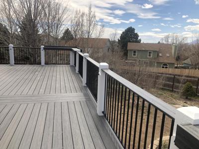 Painted Deck with Stairway, Iron Rails, Shelves & Accent Lighting built by Deck Works in Colorado Springs