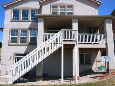 Covered Stucco Deck with Custom Rails & Stairway built by Deck Works in Colorado Springs