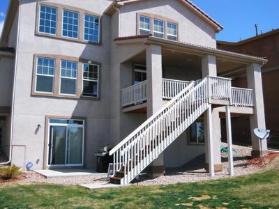 Covered Stucco Deck with Custom Rails & Stairway built by Deck Works in Colorado Springs