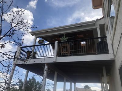Covered Deck with Iron Rails, Lighting, Heating and Fireplace built by Deck Works in Colorado Springs