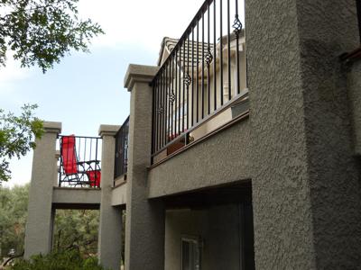 Stucco Deck with Iron Rails and Accent Lighting built by Deck Works in Colorado Springs