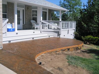 Covered Porch with Stamped Concrete Patio and Accent Lighting built by Deck Works in Colorado Springs
