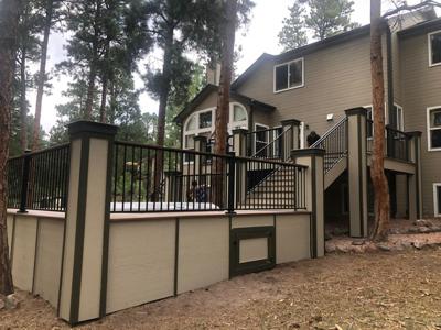 Multilevel Composite Deck with Hot Tub, Accent Lights and Iron Rails built by Deck Works in Colorado Springs