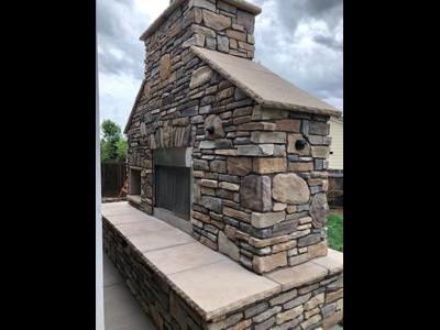 Cultured Stone Fireplace with Accent Lights built by Deck Works in Colorado Springs