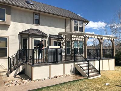 Composite Deck with Pergola, Iron Rail, Stairways and Deck Skirt built by Deck Works in Colorado Springs