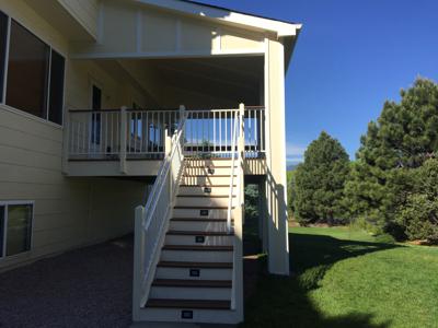 Covered Deck with Stairway, Custom Rail & Accent Lighting by Deck Works in Colorado Springs