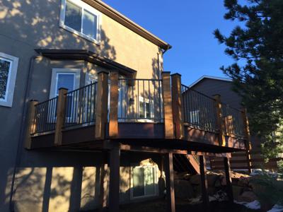 Deck with Stairway, Accent Lighting and Iron Rail by Deck Works in Colorado Springs