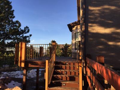 Deck with Stairway, Accent Lighting and Iron Rail by Deck Works in Colorado Springs