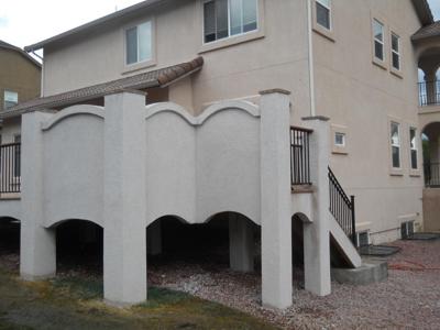 Multi Level Stucco Deck with Stairways, Iron Rial & Accent Lighting by Deck Works in Colorado Springs