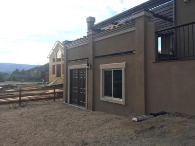 Stucco Deck Addition with Deck Cover, Iron Rail, Flower Boxes & Accent Lighting by Deck Works in Colorado Springs
