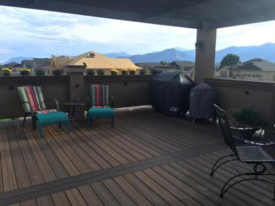 Stucco Deck Addition with Deck Cover, Iron Rail, Flower Boxes & Accent Lighting by Deck Works in Colorado Springs