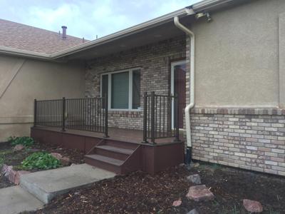 Front Porch with Iron Rail & Stairway by Deck Works in Colorado Springs