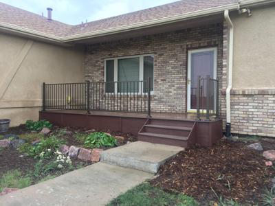 Front Porch with Iron Rail & Stairway by Deck Works in Colorado Springs