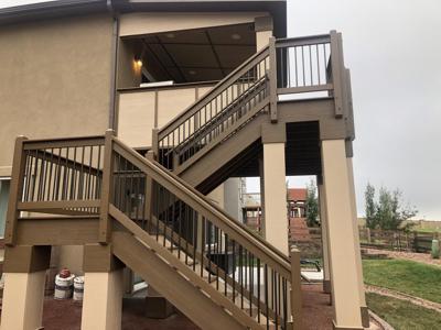 Covered Stucco Deck with Stairway, Custom Rail & Accent Lighting by Deck Works in Colorado Springs