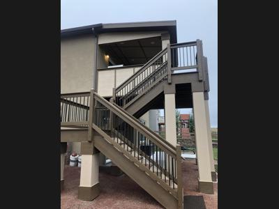 Covered Stucco Deck with Stairway, Custom Rail & Accent Lighting by Deck Works in Colorado Springs