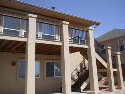 Stucco Deck with Iron Rail & Accent Lighting by Deck Works in Colorado Springs
