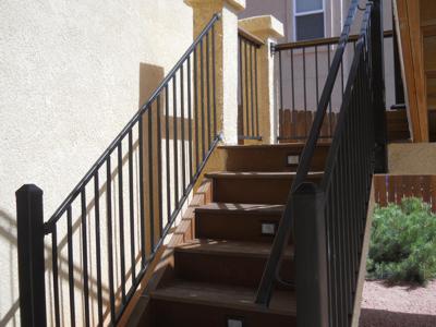 Stucco Deck with Iron Rail & Accent Lighting by Deck Works in Colorado Springs