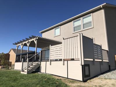 Composite Deck with Stairways, Pergola, Storage Box, Custom Rail & Wind Screen built by Deck Works in Colorado Springs