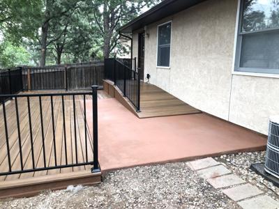 Composite Porch with Ramps and Iron Rail built by Deck Works in Colorado Springs