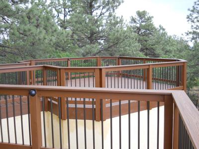 Stucco Deck with Jacuzzi Room, Storage Room, Custom Rail, Stairways, Benches & Accent Lighting bult by Deck Works in Colorado Springs