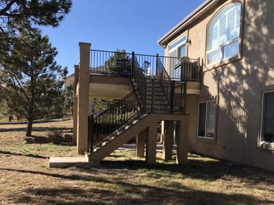 Stucco Deck with Stairway, Iron Rail & Dry Below System built by Deck Works in Colorado Springs