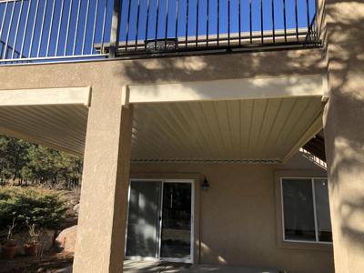 Stucco Deck with Stairway, Iron Rail & Dry Below System built by Deck Works in Colorado Springs