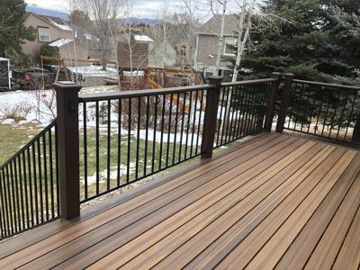 Composite Porch with Iron Rail, Stairway & Lighting built by Deck Works in Colorado Springs