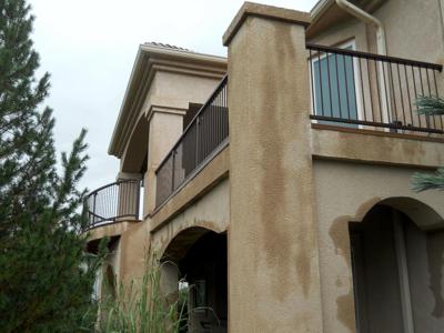 Stucco Deck with Cover, Iron Rails and Accent Lighting built by Deck Works in Colorado Springs