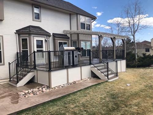 Composite Deck with Pergola, Iron Rail, Stairways and Deck Skirt Built by Deck Works in Colorado Springs